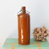 Bouteille ancienne en grès vernissé à bouchon en faïence