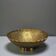 Engraved brass bowl from the mid-20th century with a scalloped edge.