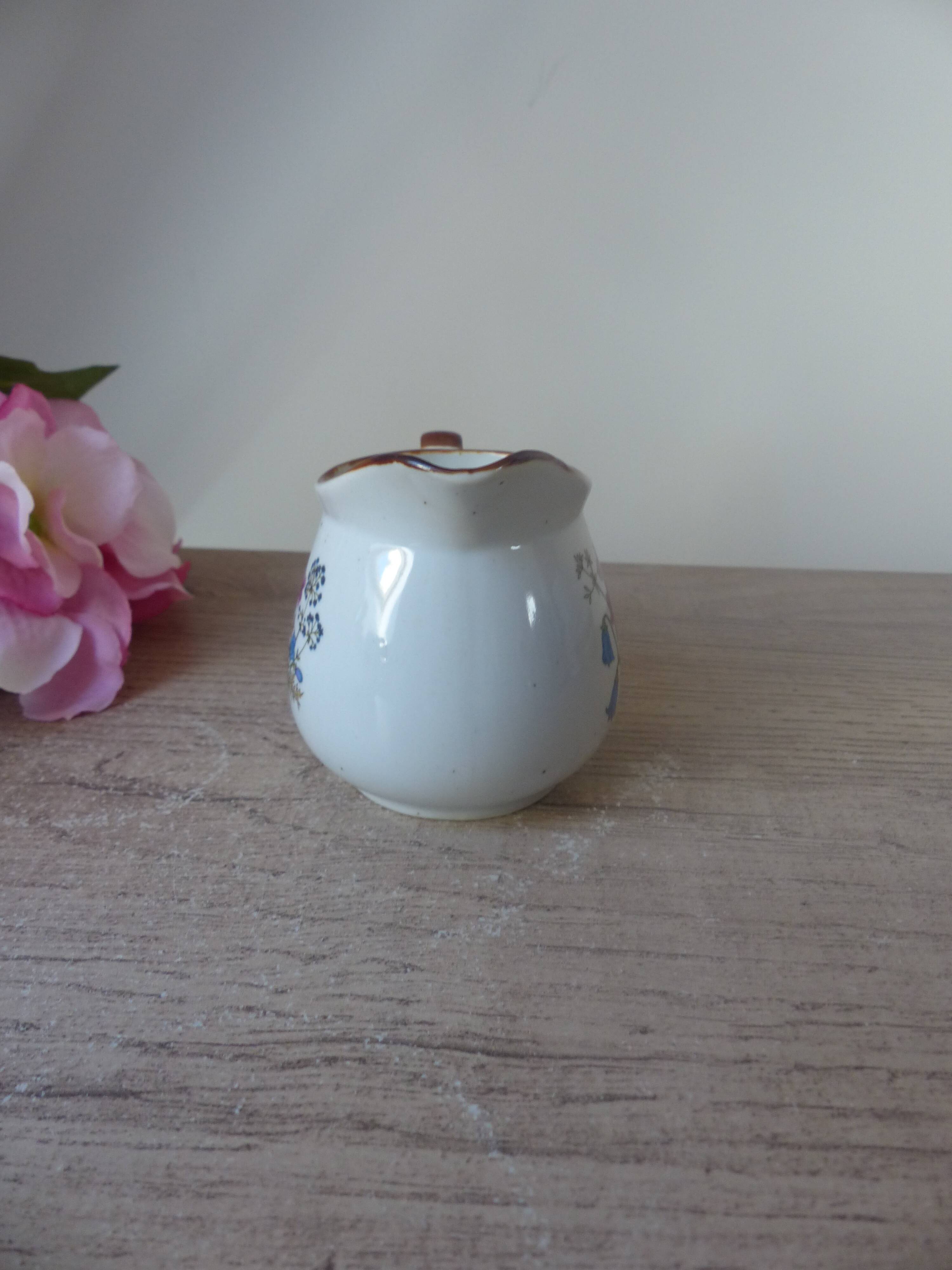 Old small artisanal milk jug in flowered speckled stoneware from the 1980s