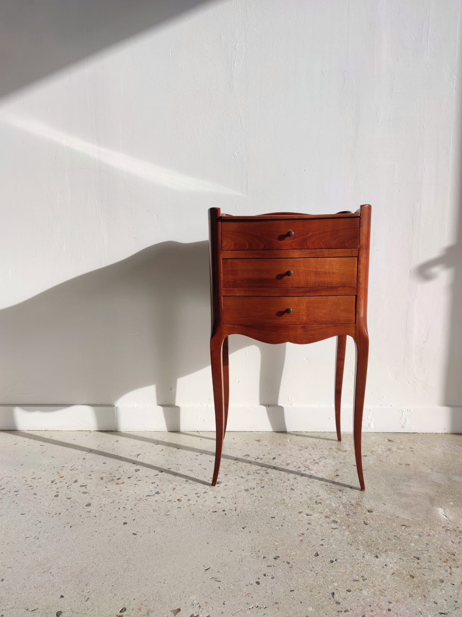 Three-drawer cherry bedside table