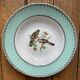Set of 7 deep plates, turquoise rim and bird pattern.