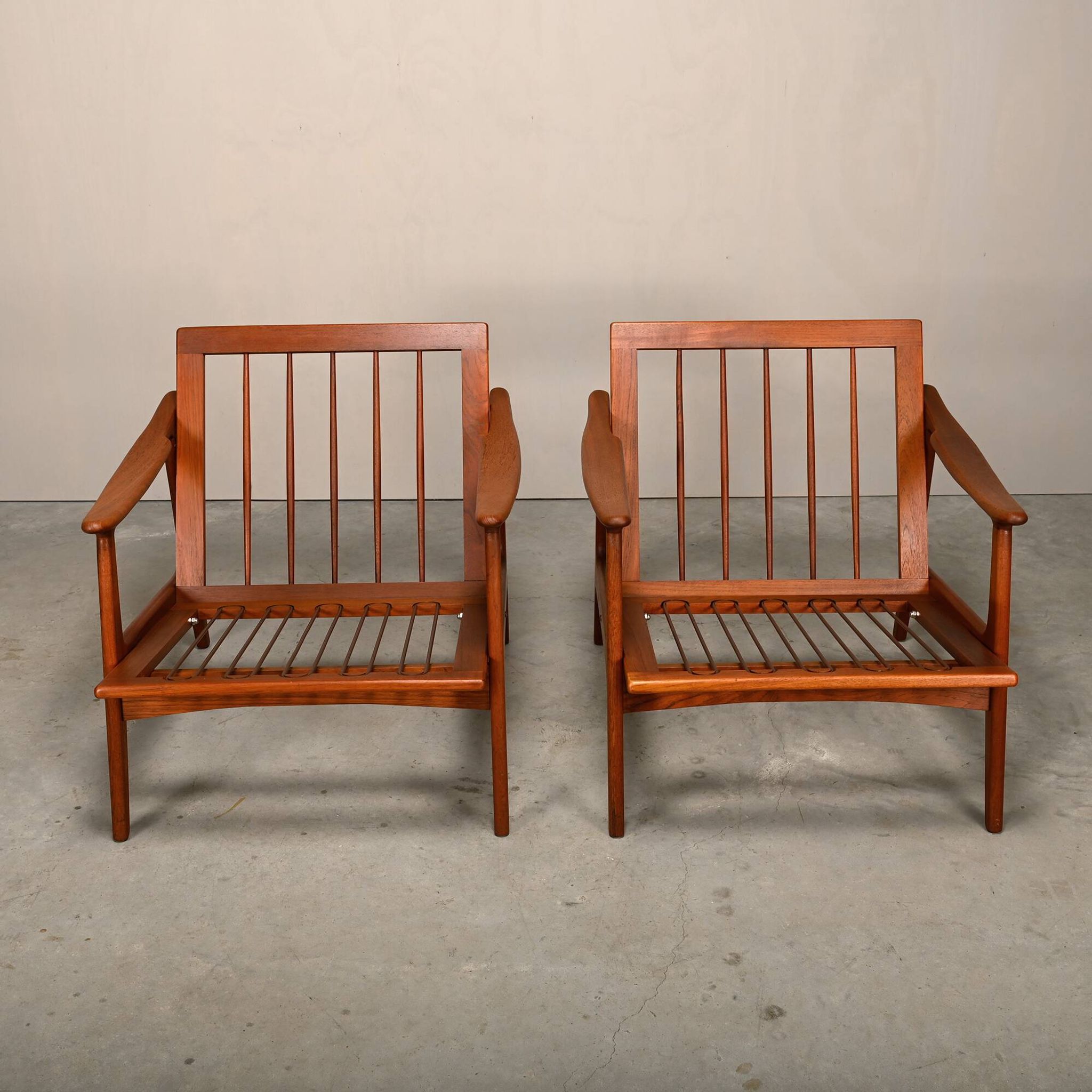 Pair Scandinavian Modern armchairs in teak and dark blue bouclé fabric