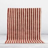 A handmade Moroccan striped terracotta rug, 150/250cm