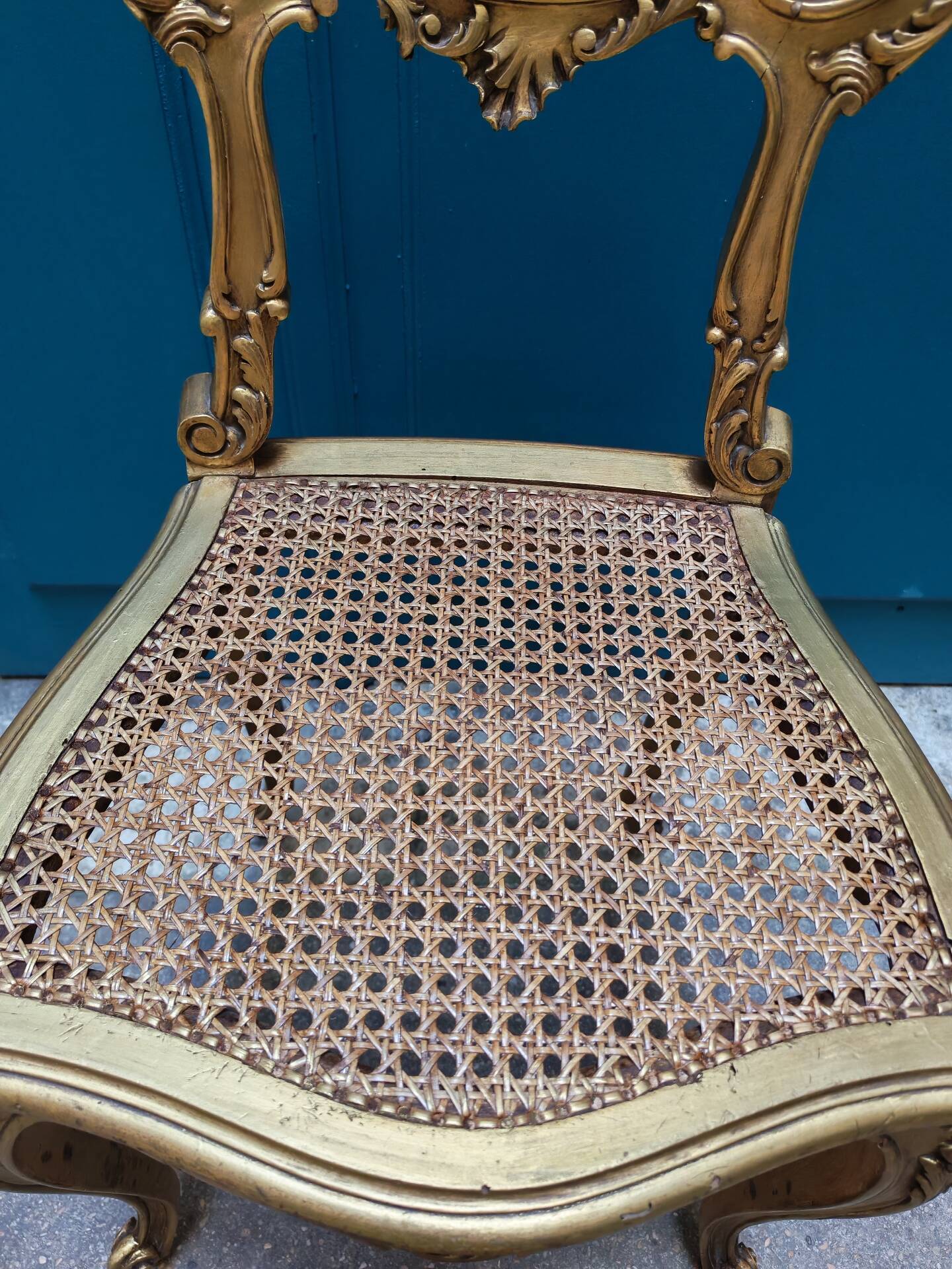 Antique rococo chair in gilded wood and caning