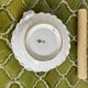Hand-held candle holder with braided ceramic bowl