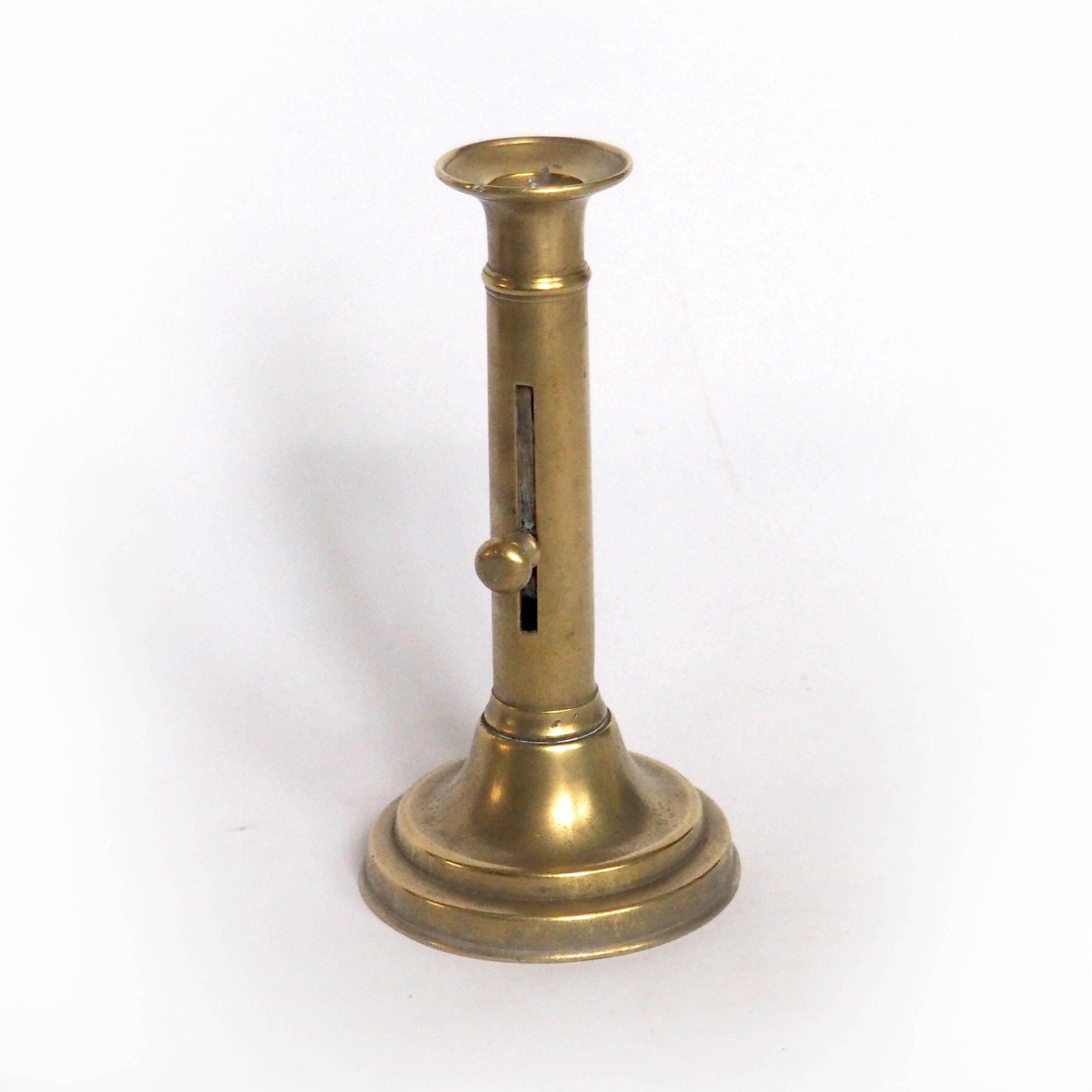 Brass candlestick with a column and bobeche.