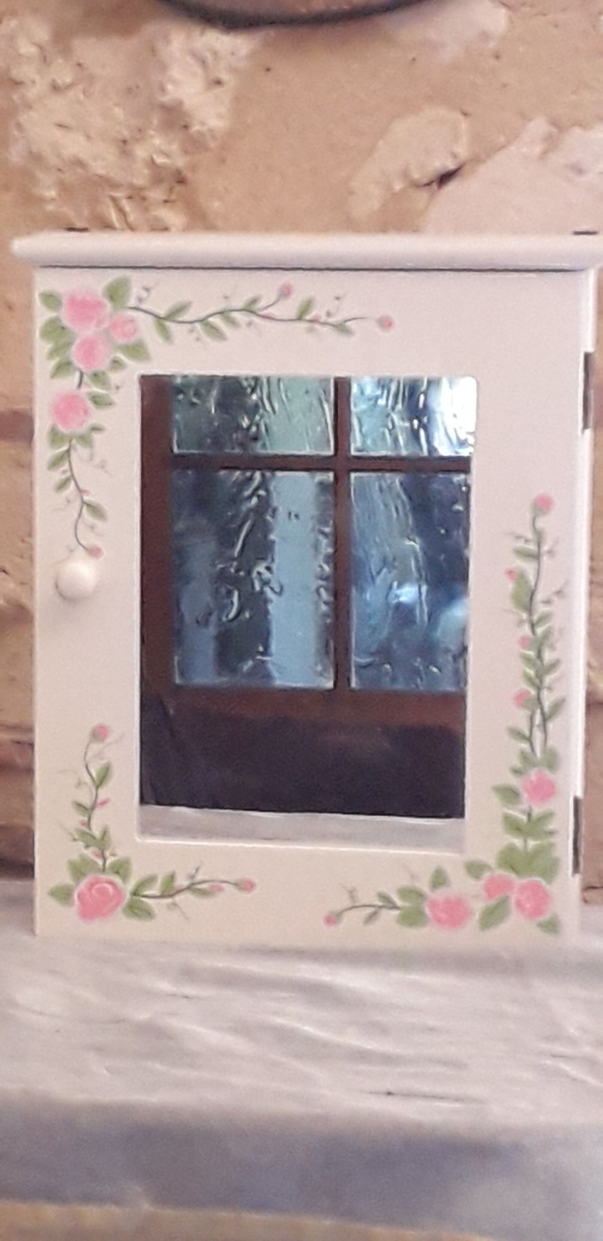 White mirrored toilet cabinet with floral pattern