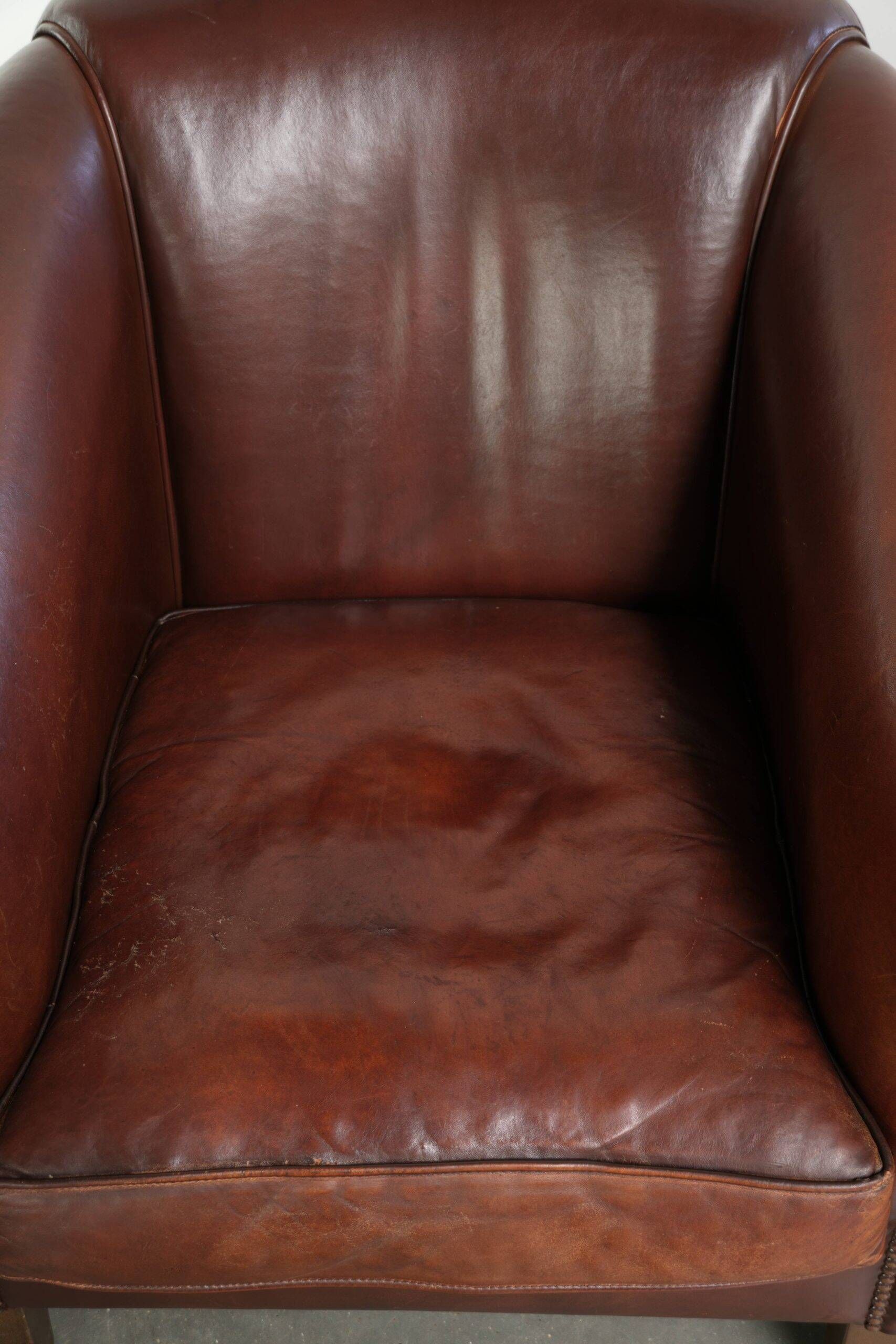 Set of 2 sheepskin club armchairs in a dark cognac colour