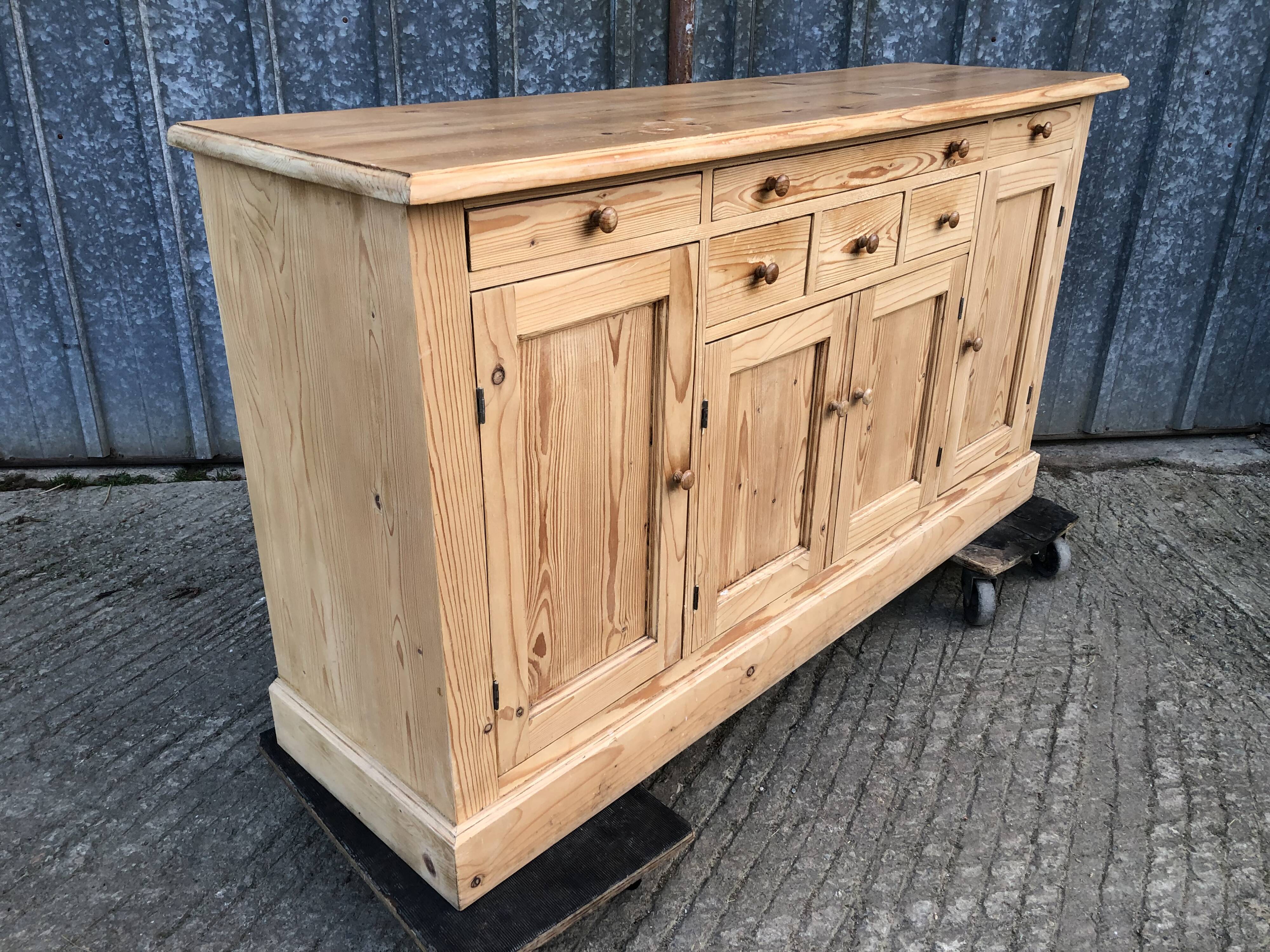 Scandinavian natural pine sideboard with 4 doors and 6 drawers.