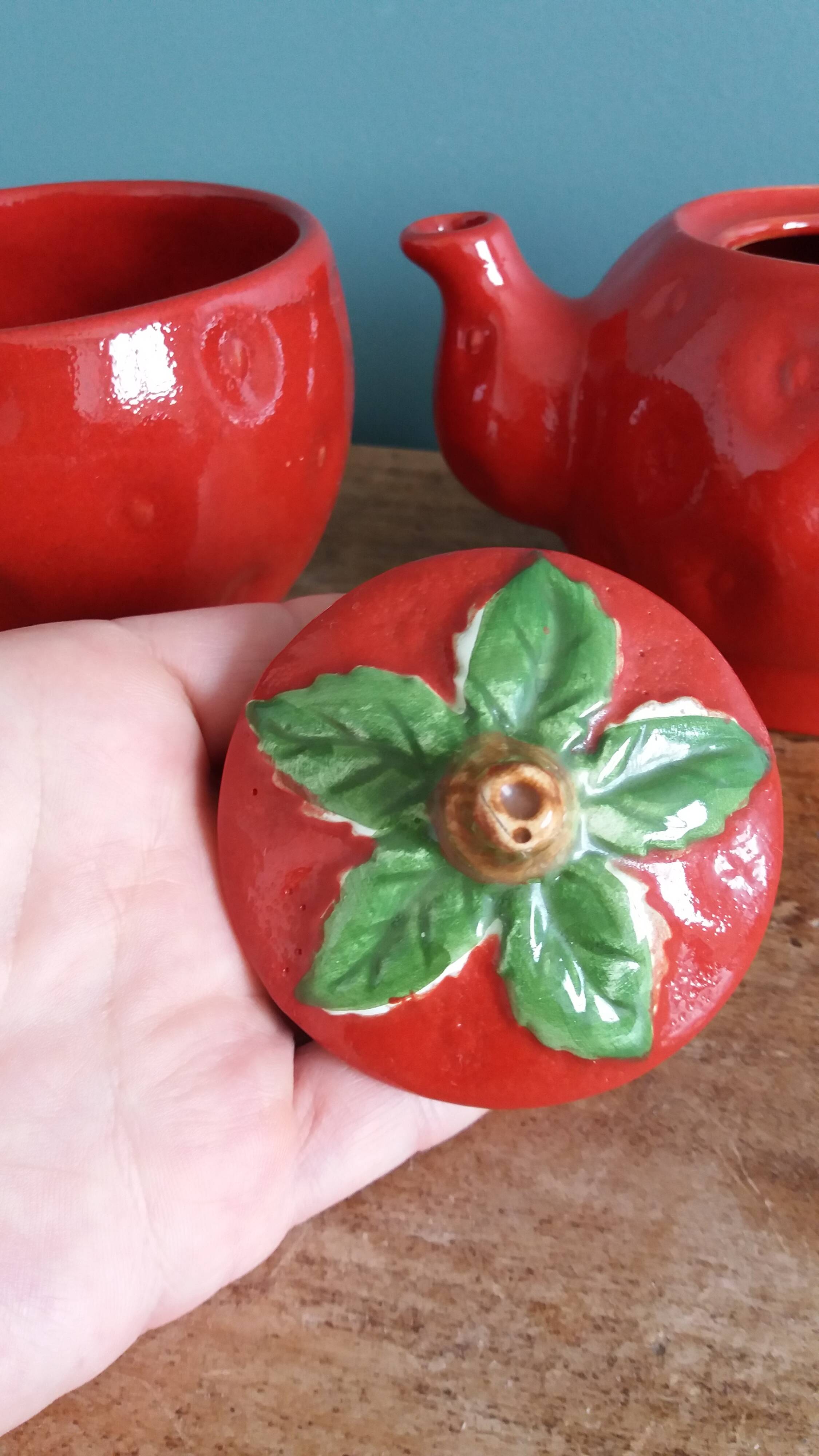 Teapot and cup in the shape of a strawberry.