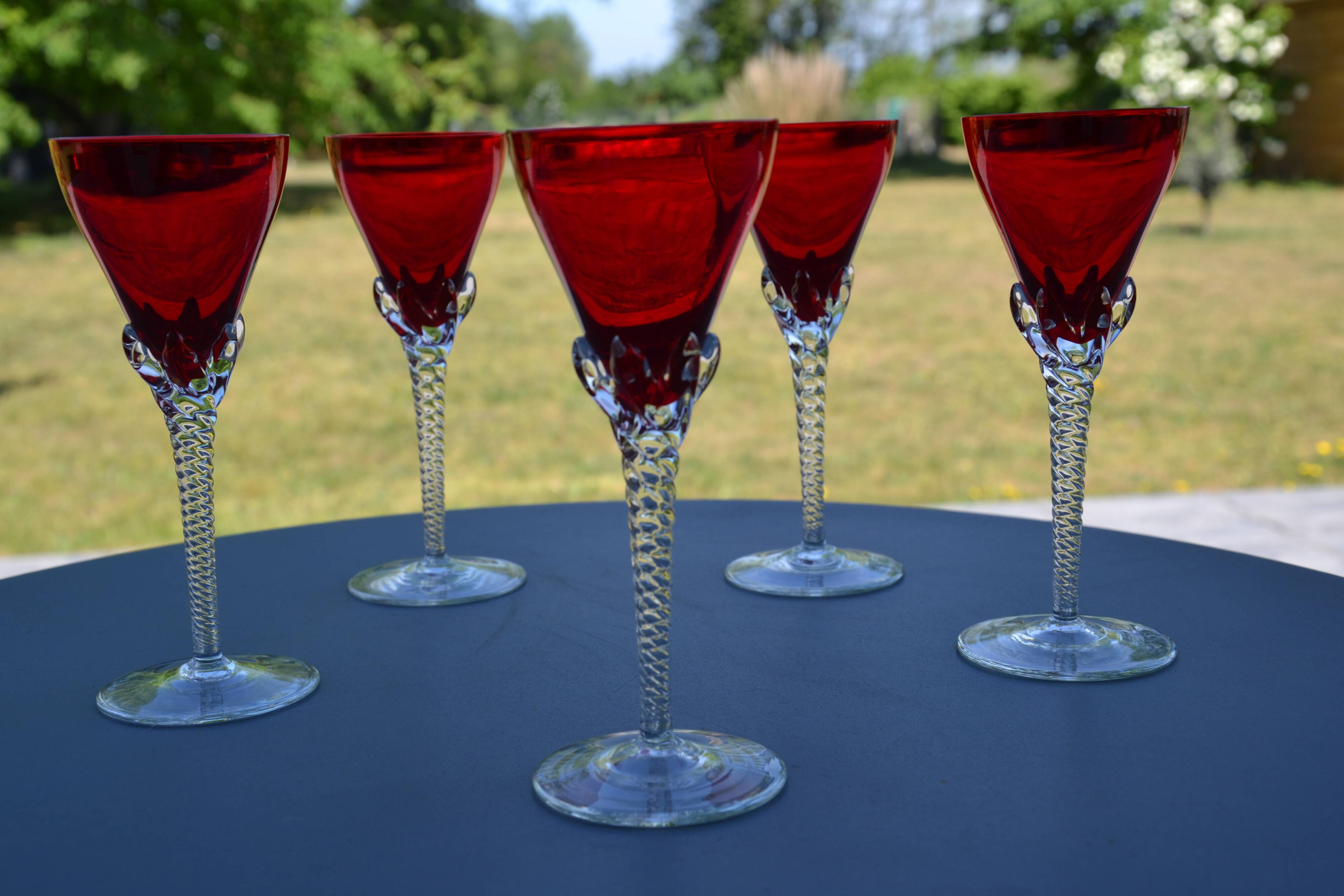 5 red crystal glasses with twisted stems