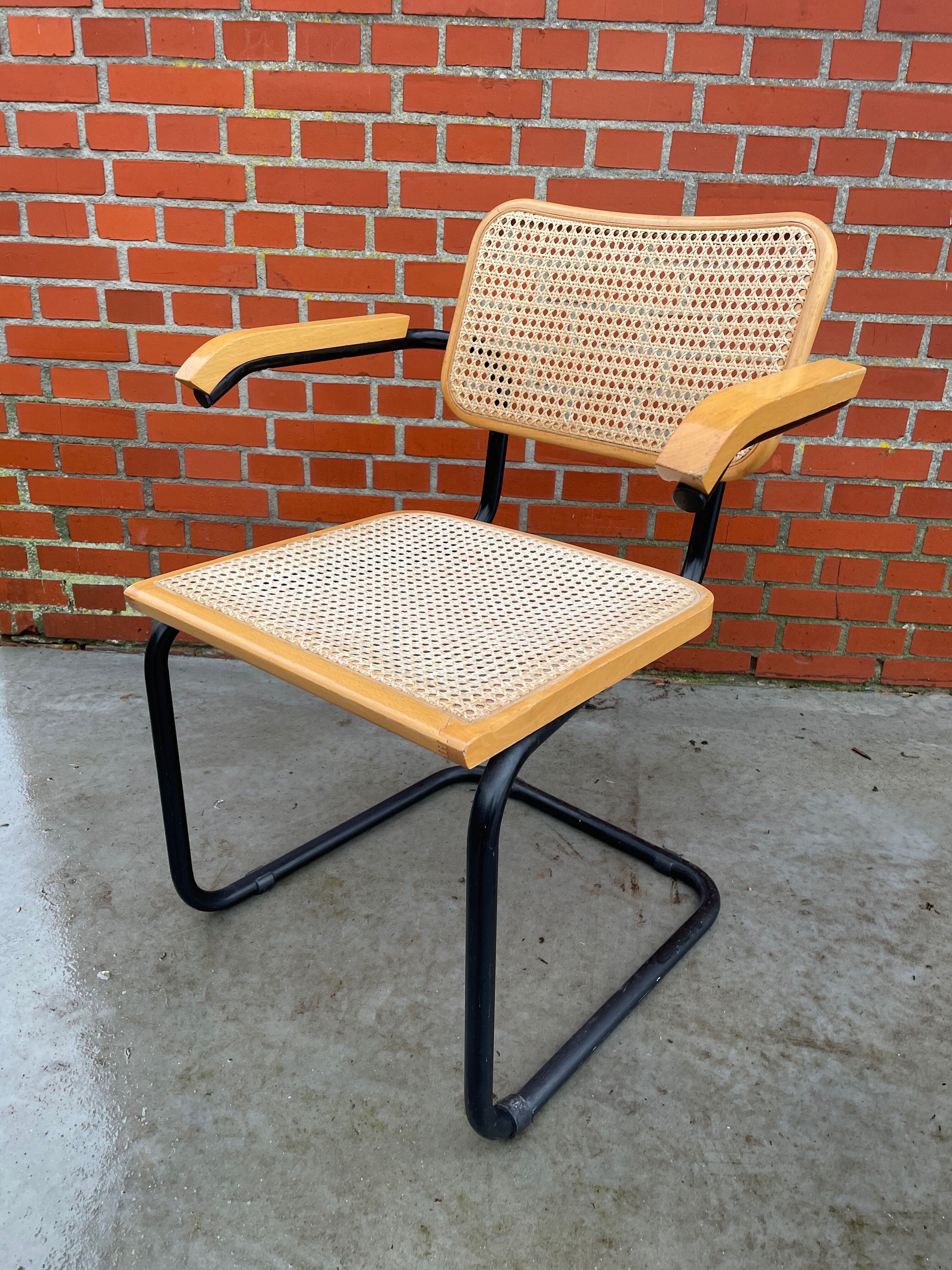 Cesca model chair designed by Marcel Breuer with black-framed armrests