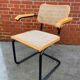 Cesca model chair designed by Marcel Breuer with black-framed armrests