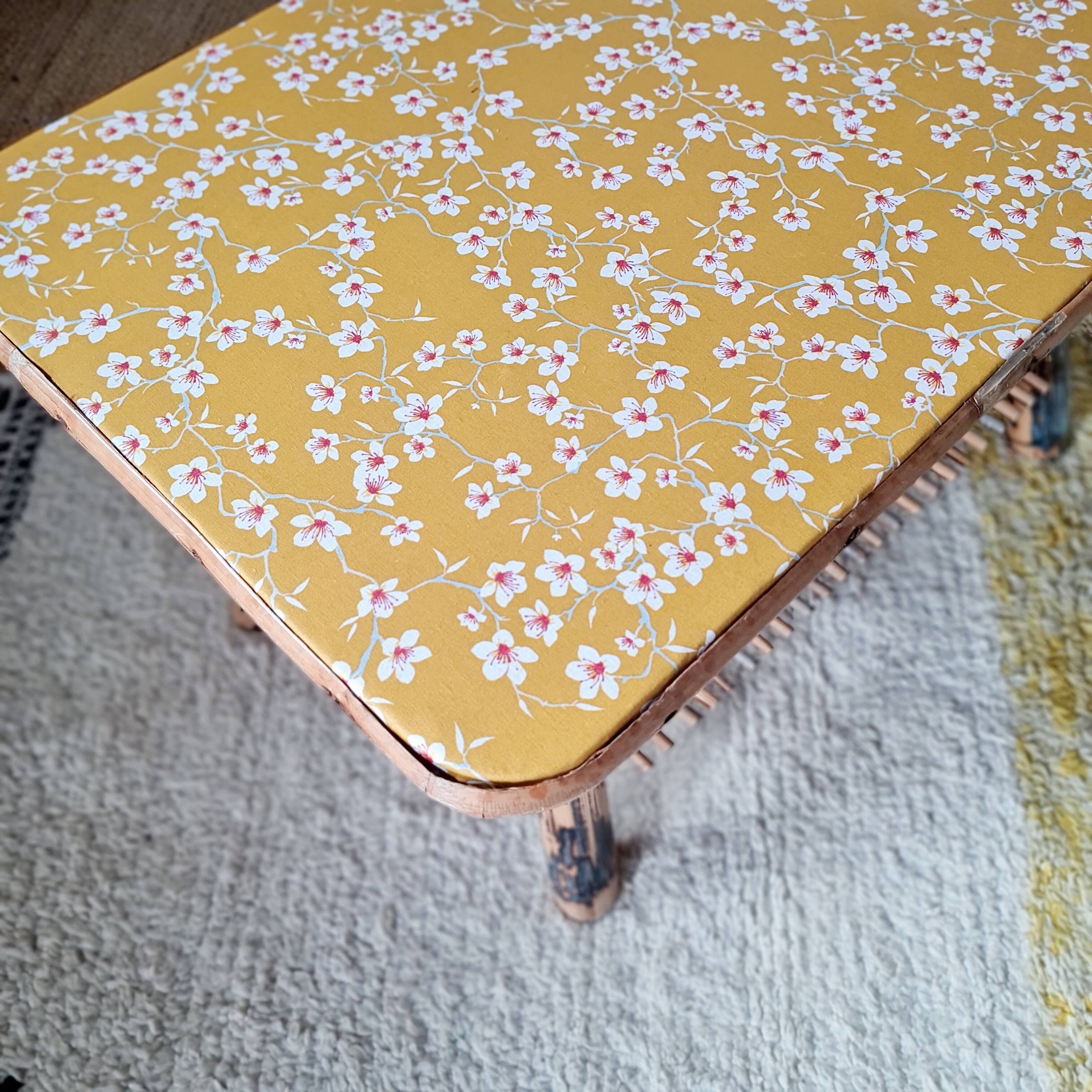 Table basse en rotin plateau tissu fleuri jaune