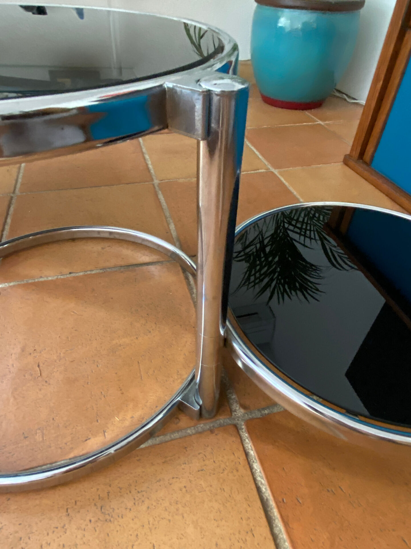 Coffee table with pivoting metal and black glass elements.