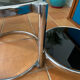 Coffee table with pivoting metal and black glass elements.