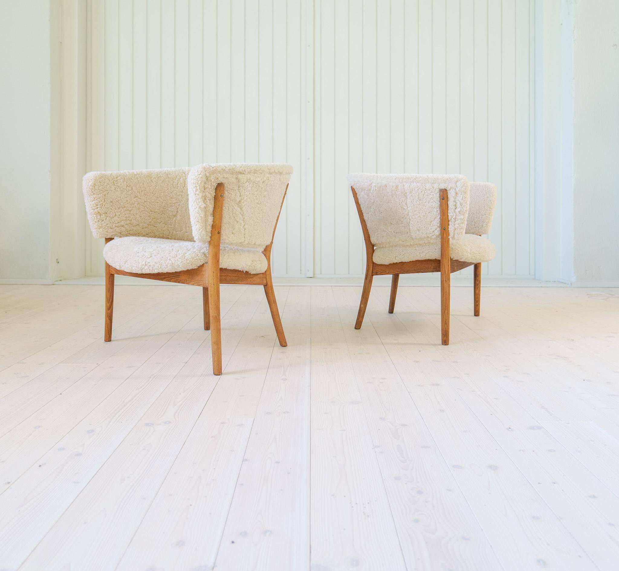 Mid-century lounge chairs in sheepskin/shearling and stained wood, Sweden, 1962.