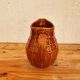 Vintage Saint Clément pitcher with a caramel checkered design.