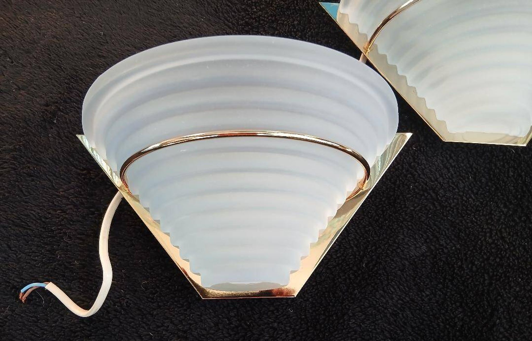 Art Deco wall lights in glass and gilded metal.