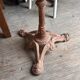 Cast iron base side table with a stone-effect top.