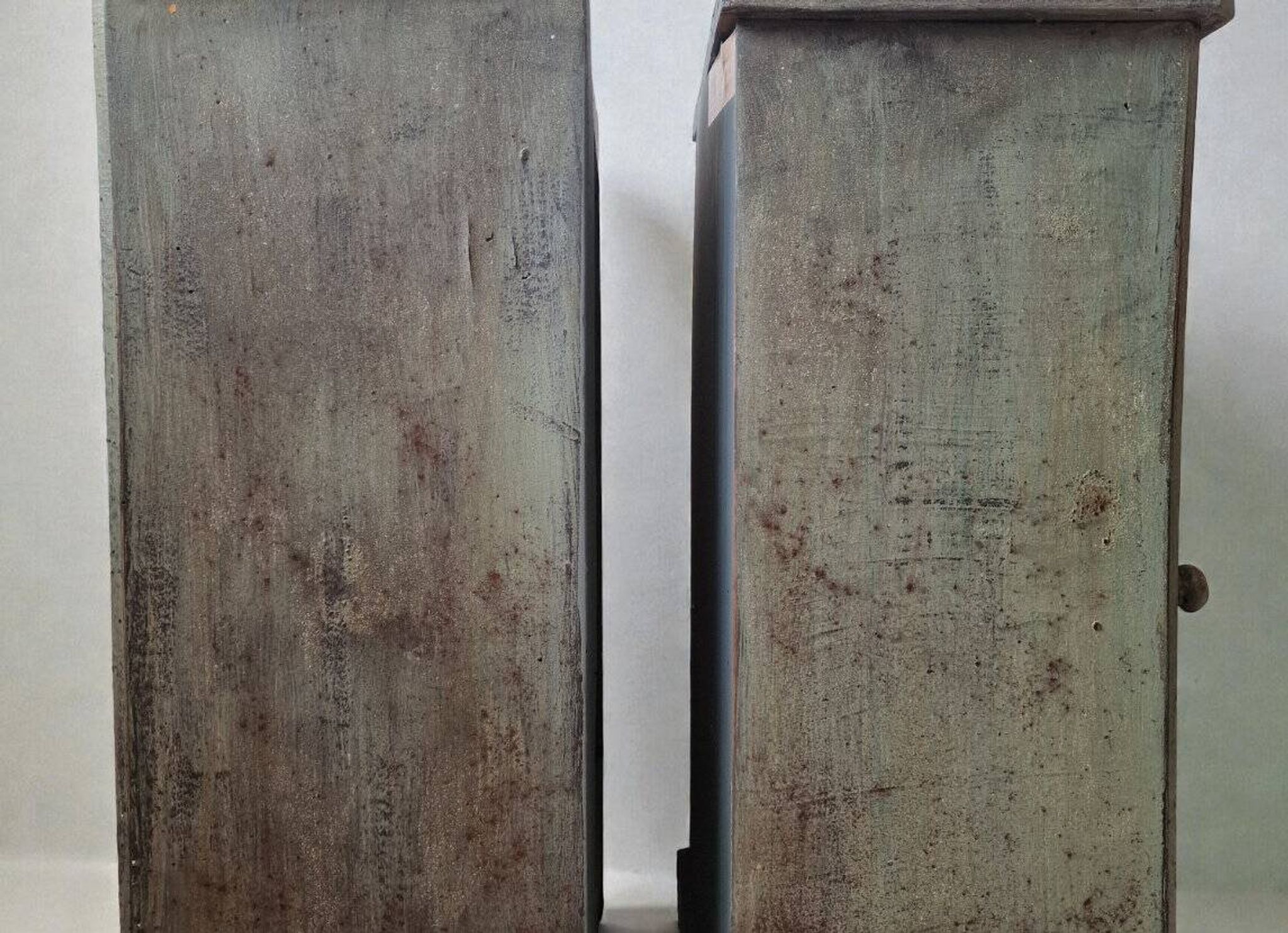 Pair of antique bedside tables with a green patina