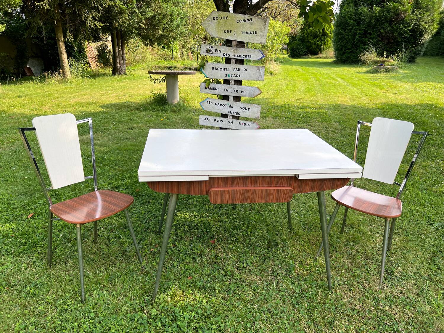 White Formica table with extensions and 2 designer chairs