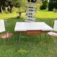 White Formica table with extensions and 2 designer chairs