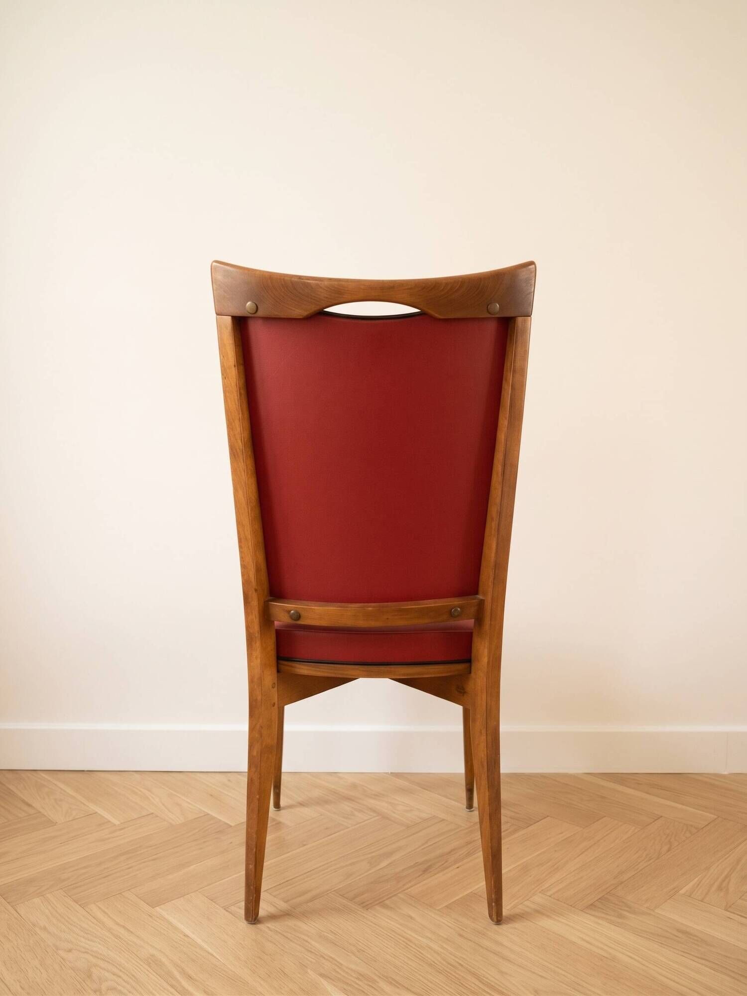 Set of 6 vintage wooden chairs with red faux leather in retro style.