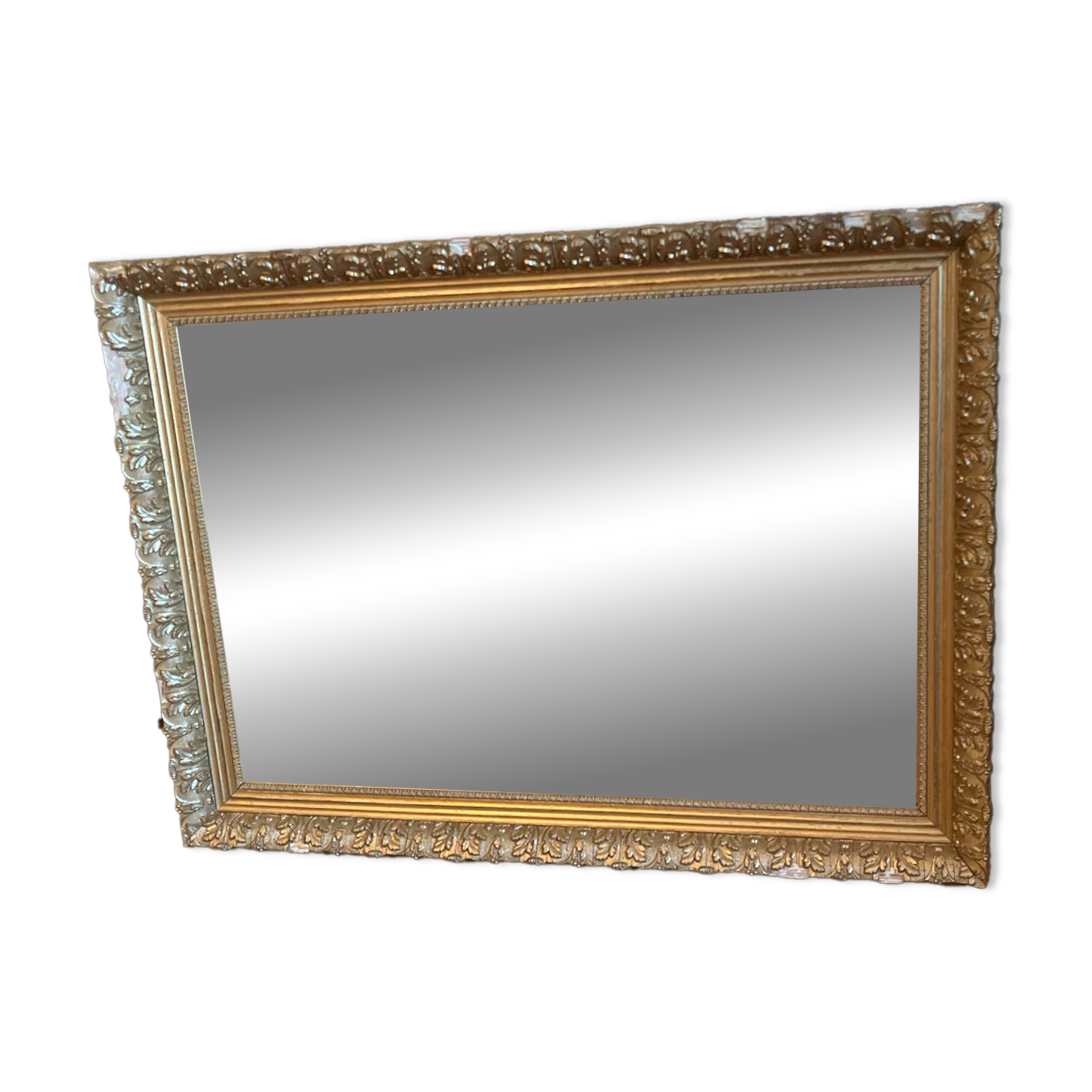 Antique mirror with a wooden and gilded stucco frame.