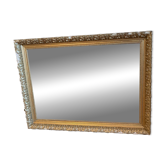 Antique mirror with a wooden and gilded stucco frame.