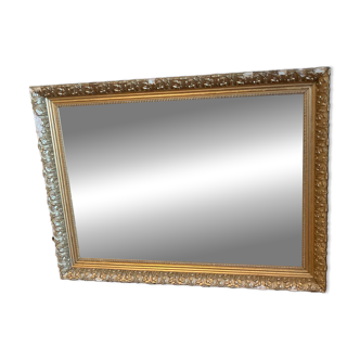 Antique mirror with a wooden frame and gilded stucco