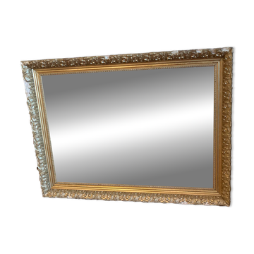 Antique mirror with a wooden and gilded stucco frame.