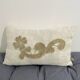 Cushion in vintage fabric with ornamentation.