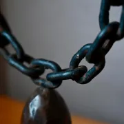 Sculpted wooden and wrought iron brutalist double chandelier from the 1960s.