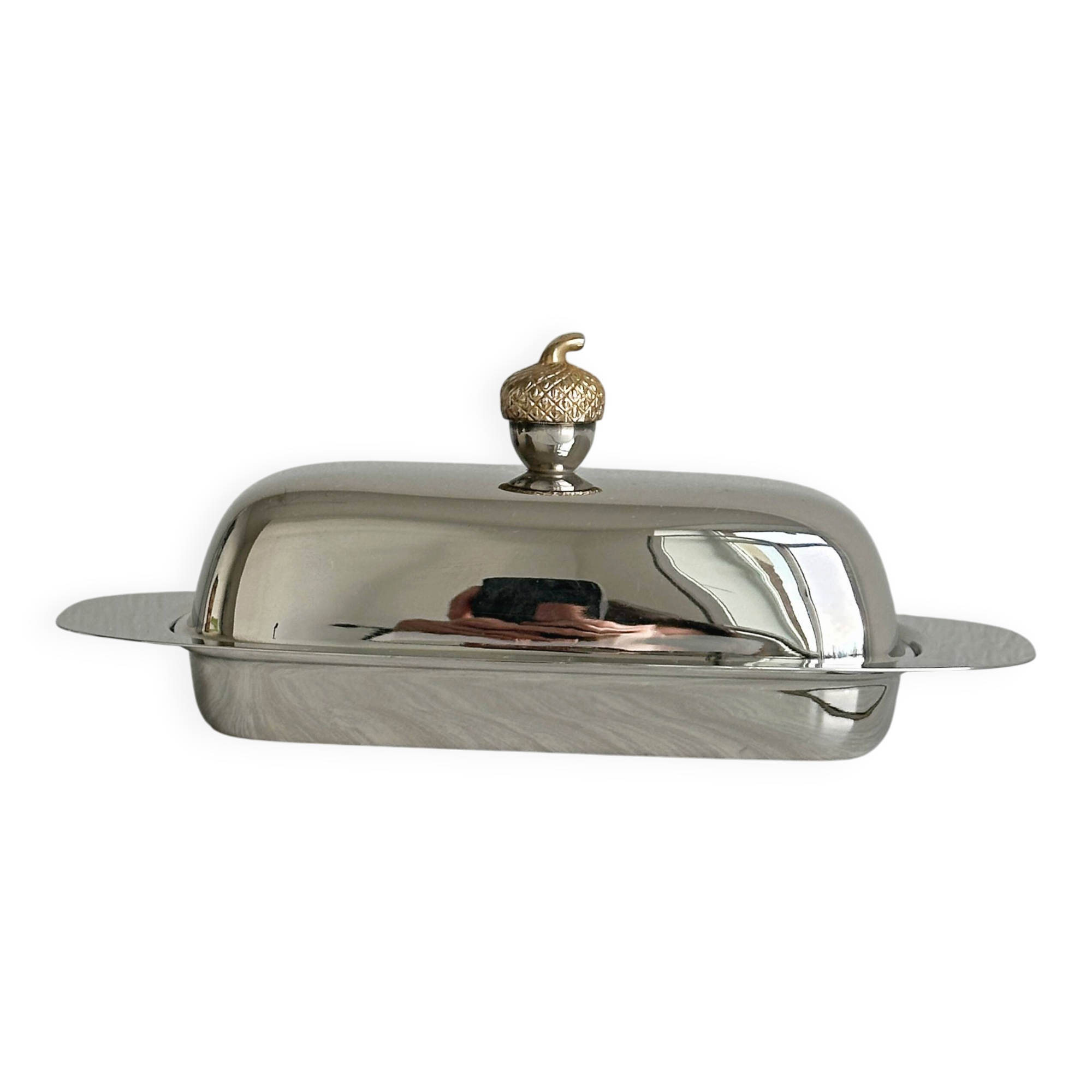 stainless steel butter dish with a golden knob