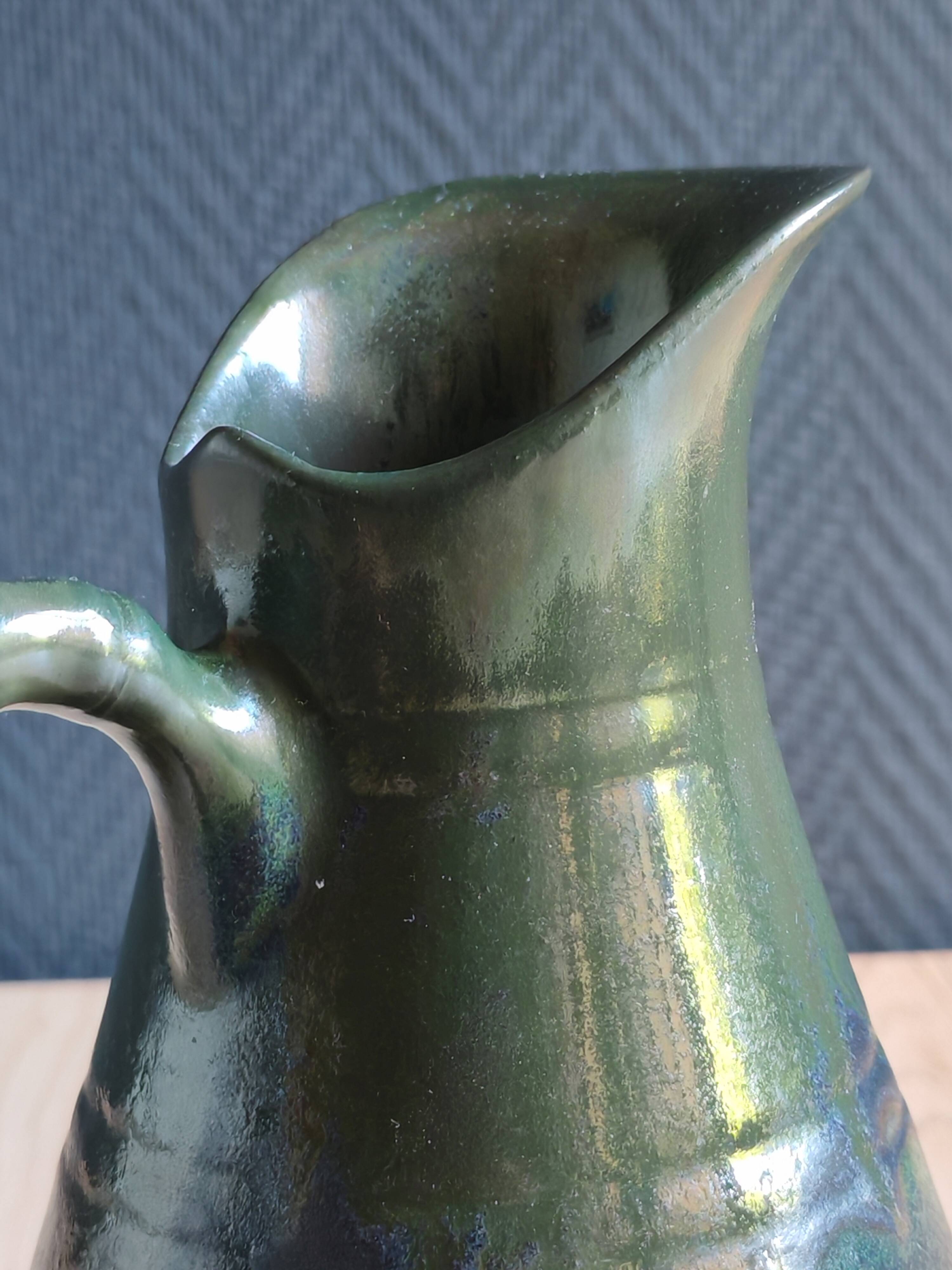 Vintage ceramic pitcher vase in glazed green and blue.