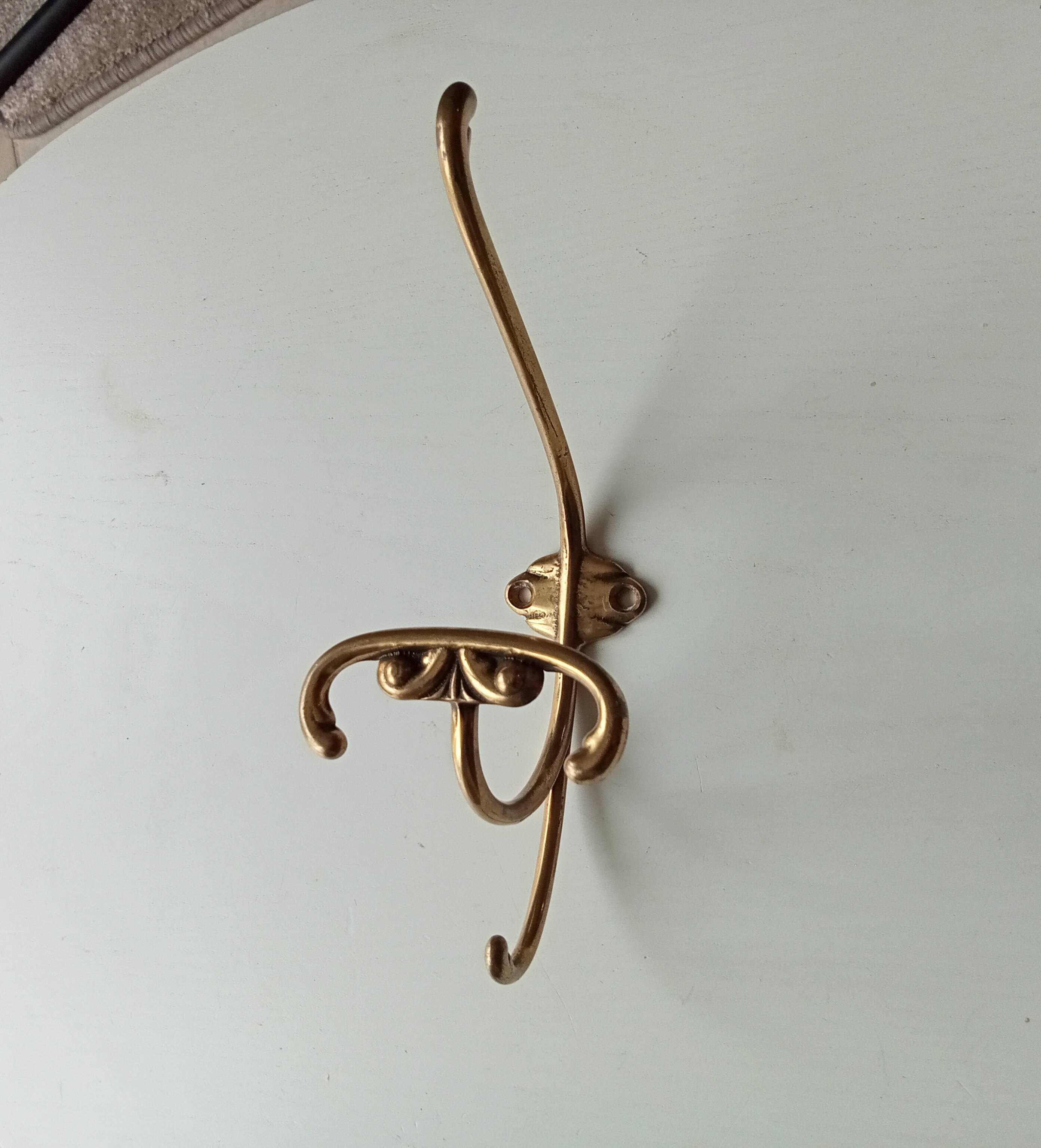 Old coat hook in solid golden brass