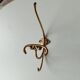 Old coat hook in solid golden brass