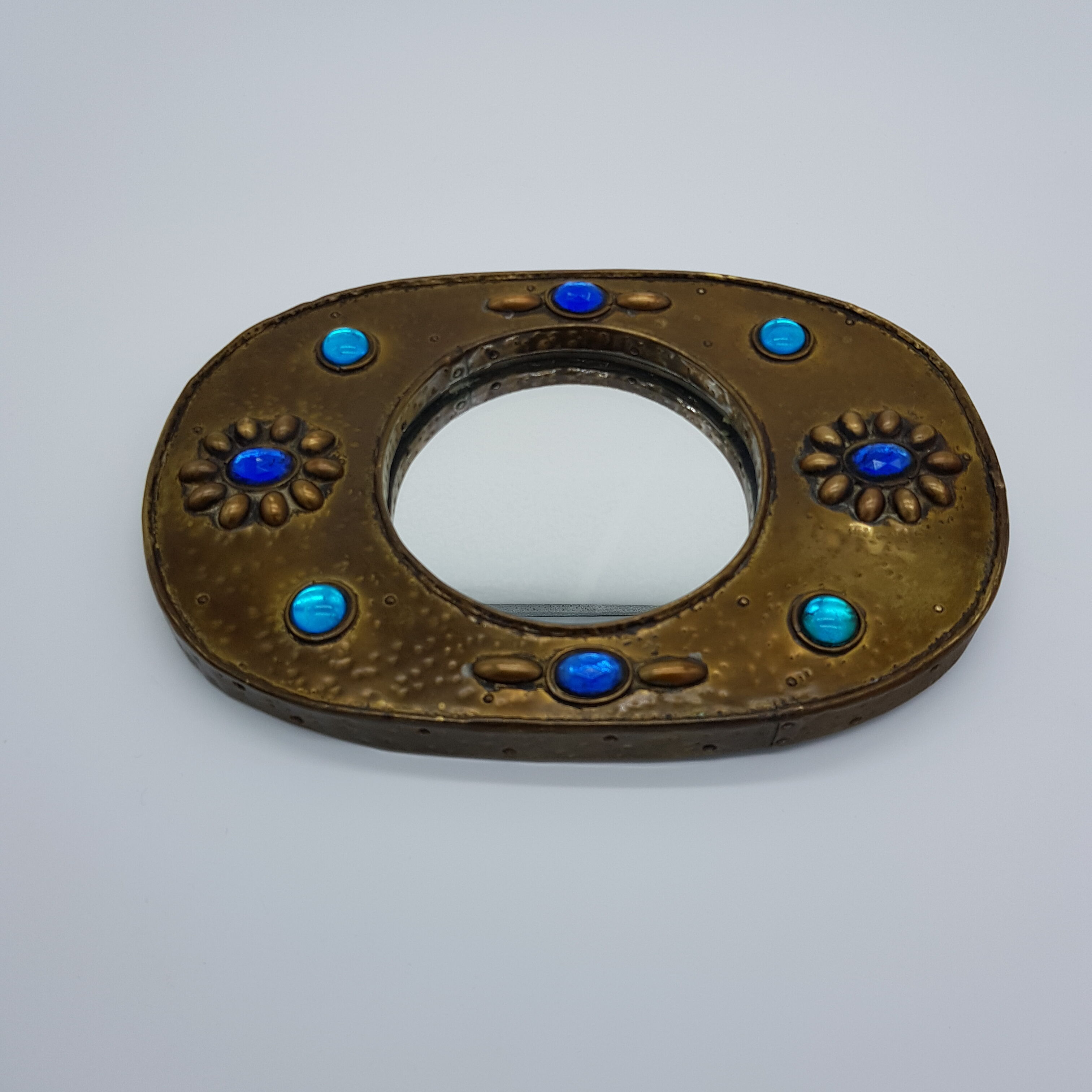 Brass oval mirror and blue cabochons