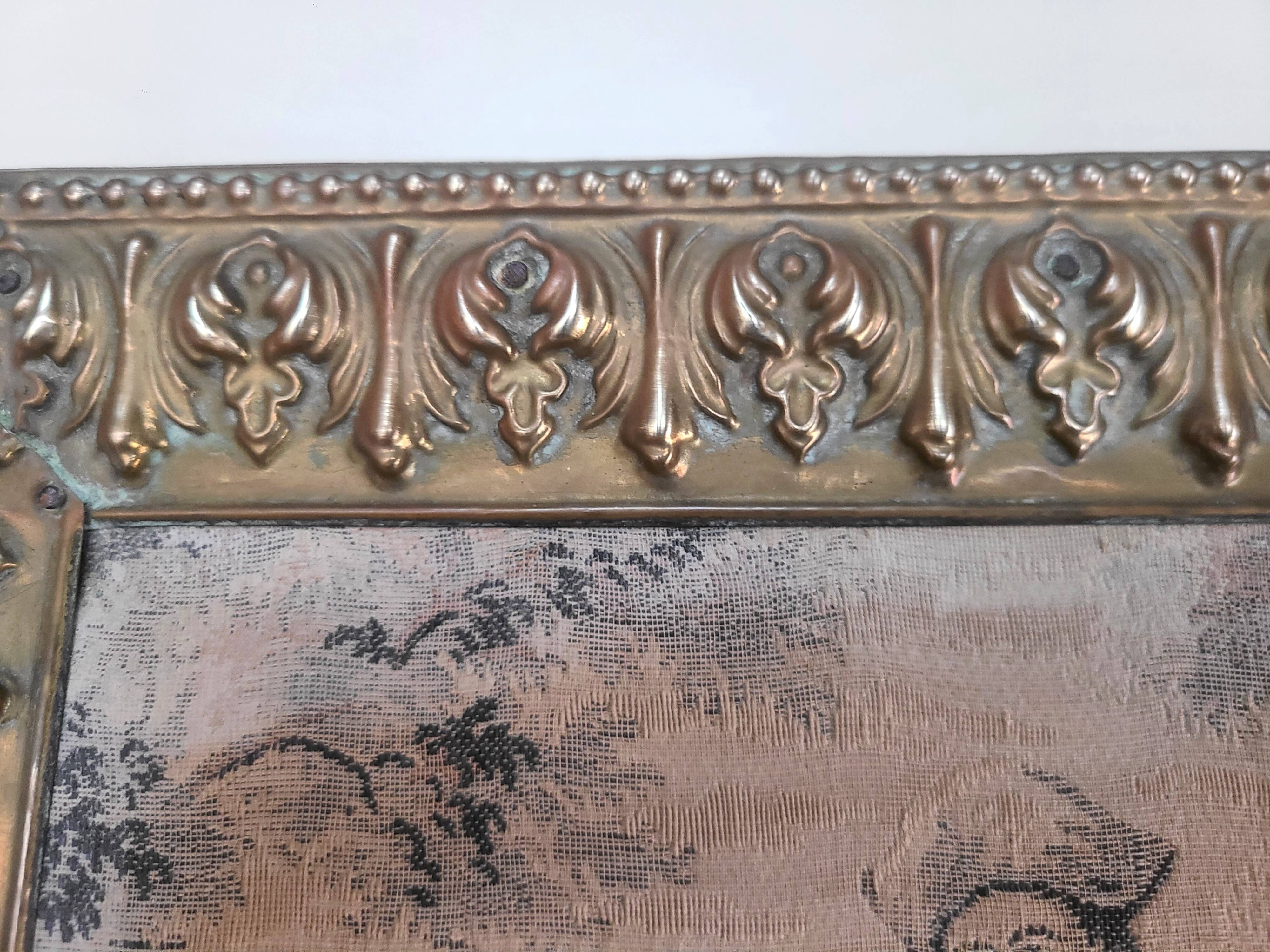 Antique tapestries framed in repoussé brass.