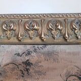 Antique tapestries framed in repoussé brass.