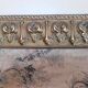 Antique tapestries framed in repoussé brass.