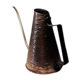 Old watering can in red copper and brass