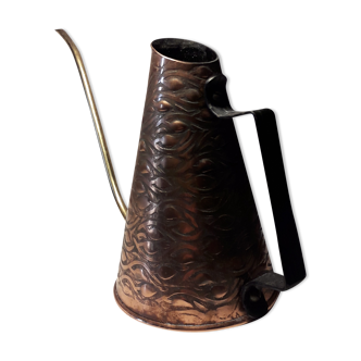 Old watering can in red copper and brass