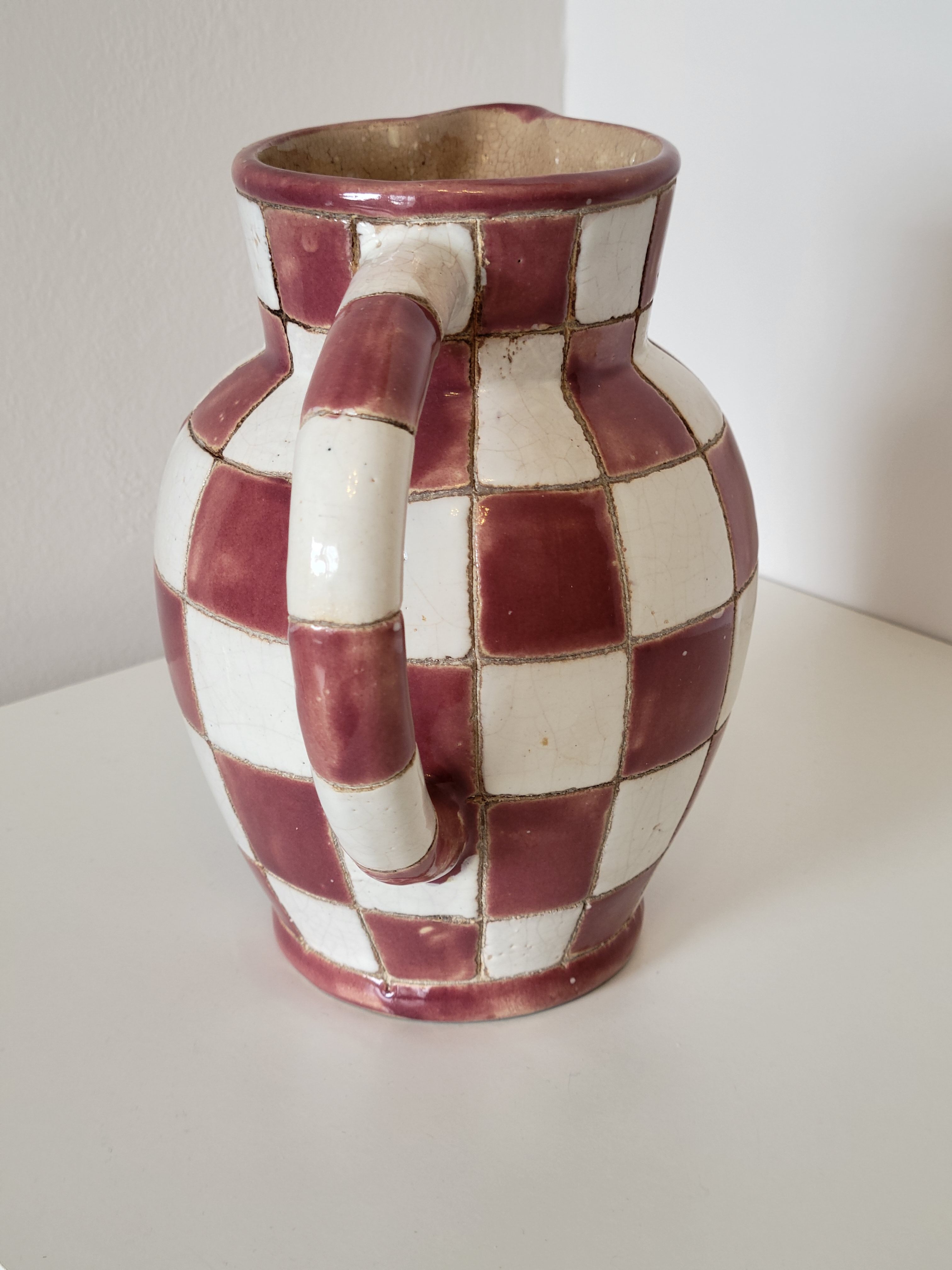 Old ceramic pitcher pattern checkerboard tiles