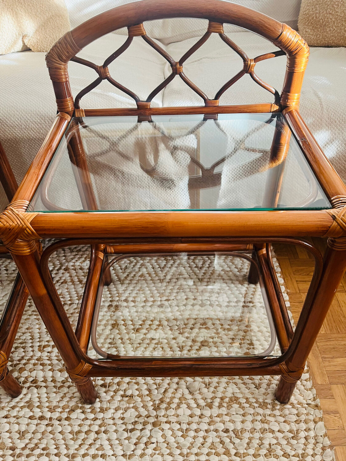 Two rattan and glass bedside tables