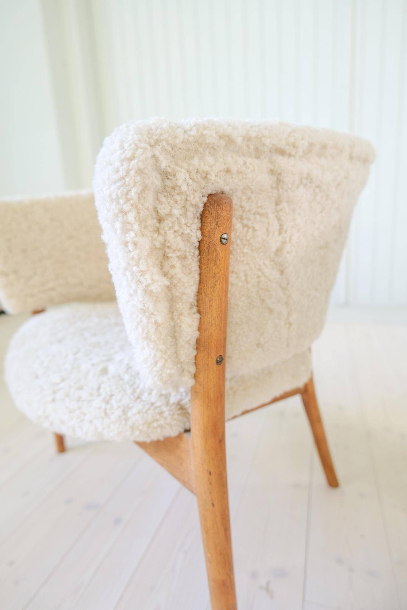 Mid-century lounge chairs in sheepskin/shearling and stained wood, Sweden, 1962.