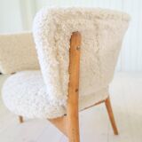 Mid-century lounge chairs in sheepskin/shearling and stained wood, Sweden, 1962.