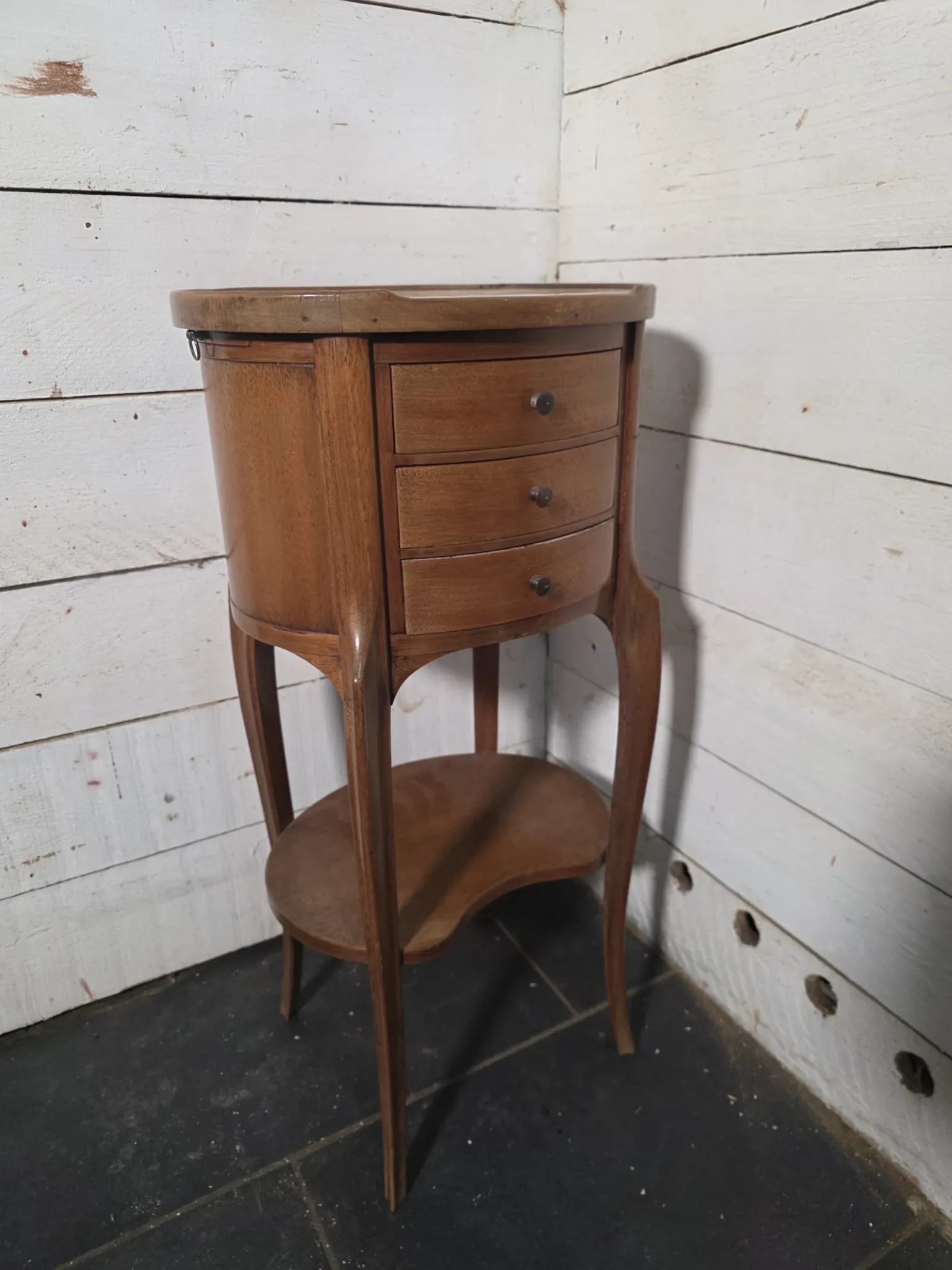 Oval bedside table in Louis XV style made of mahogany.