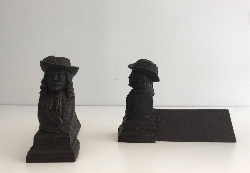 Pair of cast iron andirons in the likeness of a musketeer
